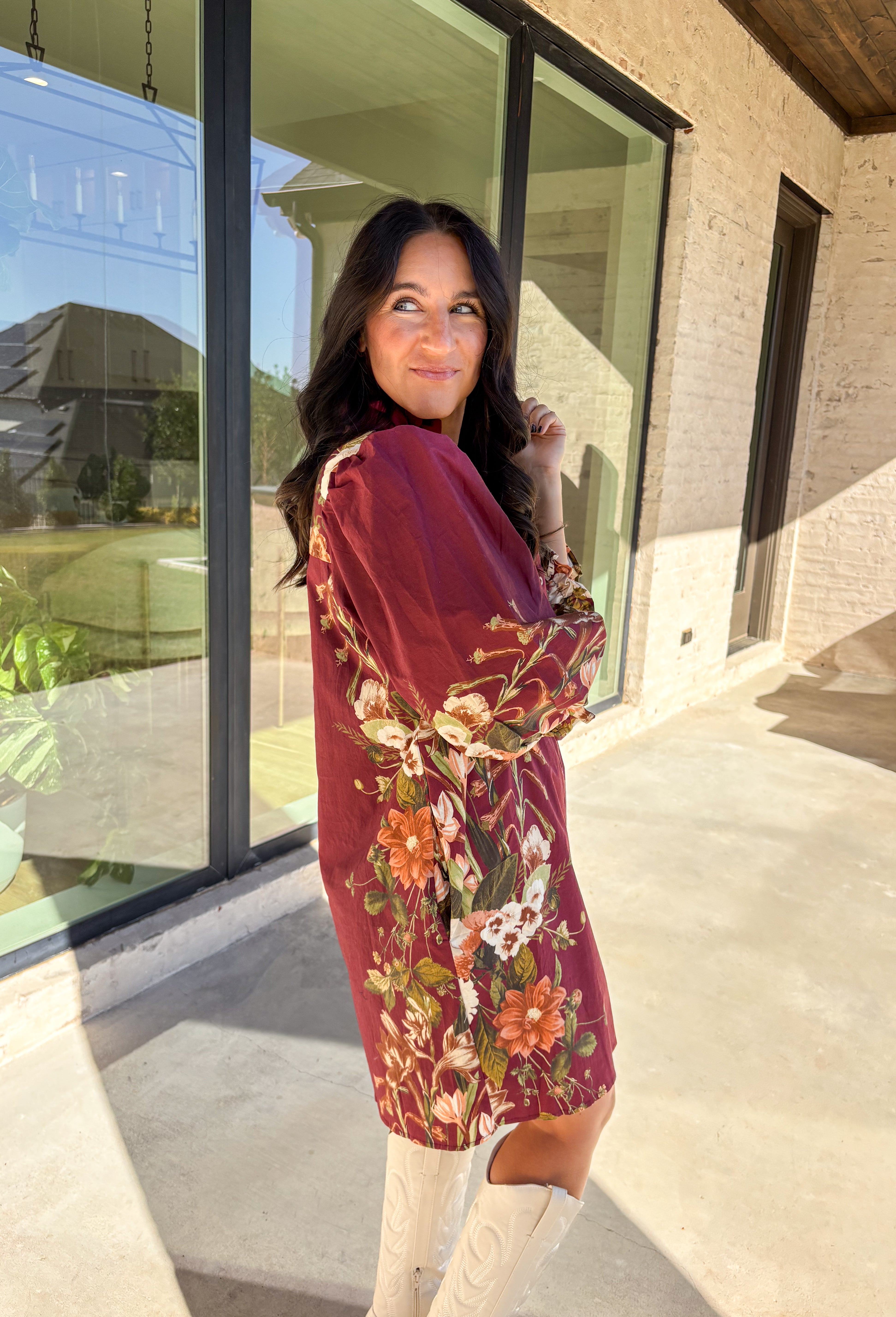 This burgundy button-down dress by Entro is a timeless piece with a fall-ready twist. Featuring a delicate floral print along the sides, it’s designed with a ruffled accent v-neckline for a touch of femininity. The elastic sleeves make for an easy, comfortable fit, while the full lining ensures effortless wear. With its rich color and flattering silhouette, this dress transitions seamlessly from day to night.