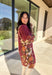 This burgundy button-down dress by Entro is a timeless piece with a fall-ready twist. Featuring a delicate floral print along the sides, it’s designed with a ruffled accent v-neckline for a touch of femininity. The elastic sleeves make for an easy, comfortable fit, while the full lining ensures effortless wear. With its rich color and flattering silhouette, this dress transitions seamlessly from day to night.