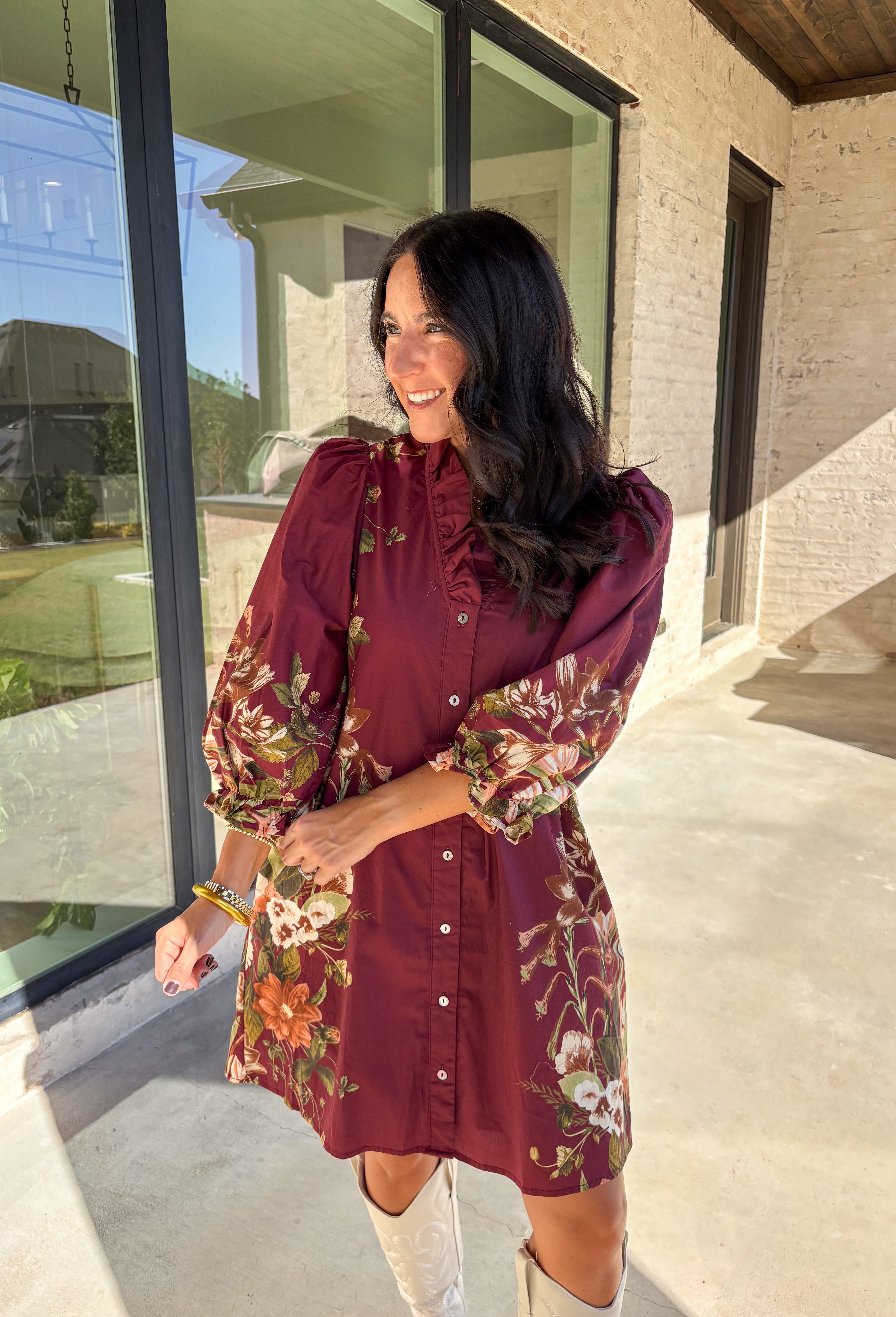 This burgundy button-down dress by Entro is a timeless piece with a fall-ready twist. Featuring a delicate floral print along the sides, it’s designed with a ruffled accent v-neckline for a touch of femininity. The elastic sleeves make for an easy, comfortable fit, while the full lining ensures effortless wear. With its rich color and flattering silhouette, this dress transitions seamlessly from day to night.