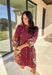 This burgundy button-down dress by Entro is a timeless piece with a fall-ready twist. Featuring a delicate floral print along the sides, it’s designed with a ruffled accent v-neckline for a touch of femininity. The elastic sleeves make for an easy, comfortable fit, while the full lining ensures effortless wear. With its rich color and flattering silhouette, this dress transitions seamlessly from day to night.