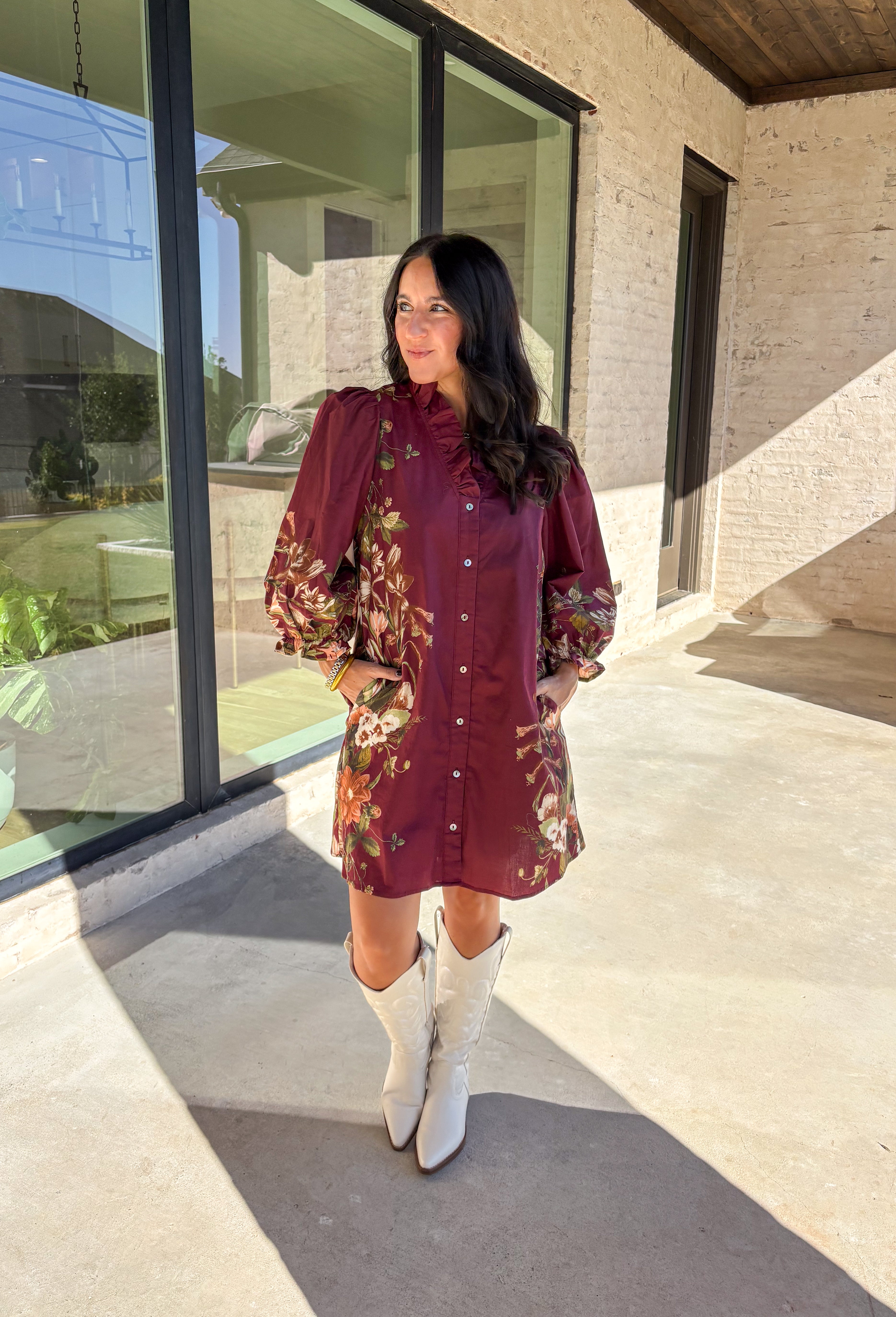 This burgundy button-down dress by Entro is a timeless piece with a fall-ready twist. Featuring a delicate floral print along the sides, it’s designed with a ruffled accent v-neckline for a touch of femininity. The elastic sleeves make for an easy, comfortable fit, while the full lining ensures effortless wear. With its rich color and flattering silhouette, this dress transitions seamlessly from day to night.