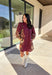 This burgundy button-down dress by Entro is a timeless piece with a fall-ready twist. Featuring a delicate floral print along the sides, it’s designed with a ruffled accent v-neckline for a touch of femininity. The elastic sleeves make for an easy, comfortable fit, while the full lining ensures effortless wear. With its rich color and flattering silhouette, this dress transitions seamlessly from day to night.