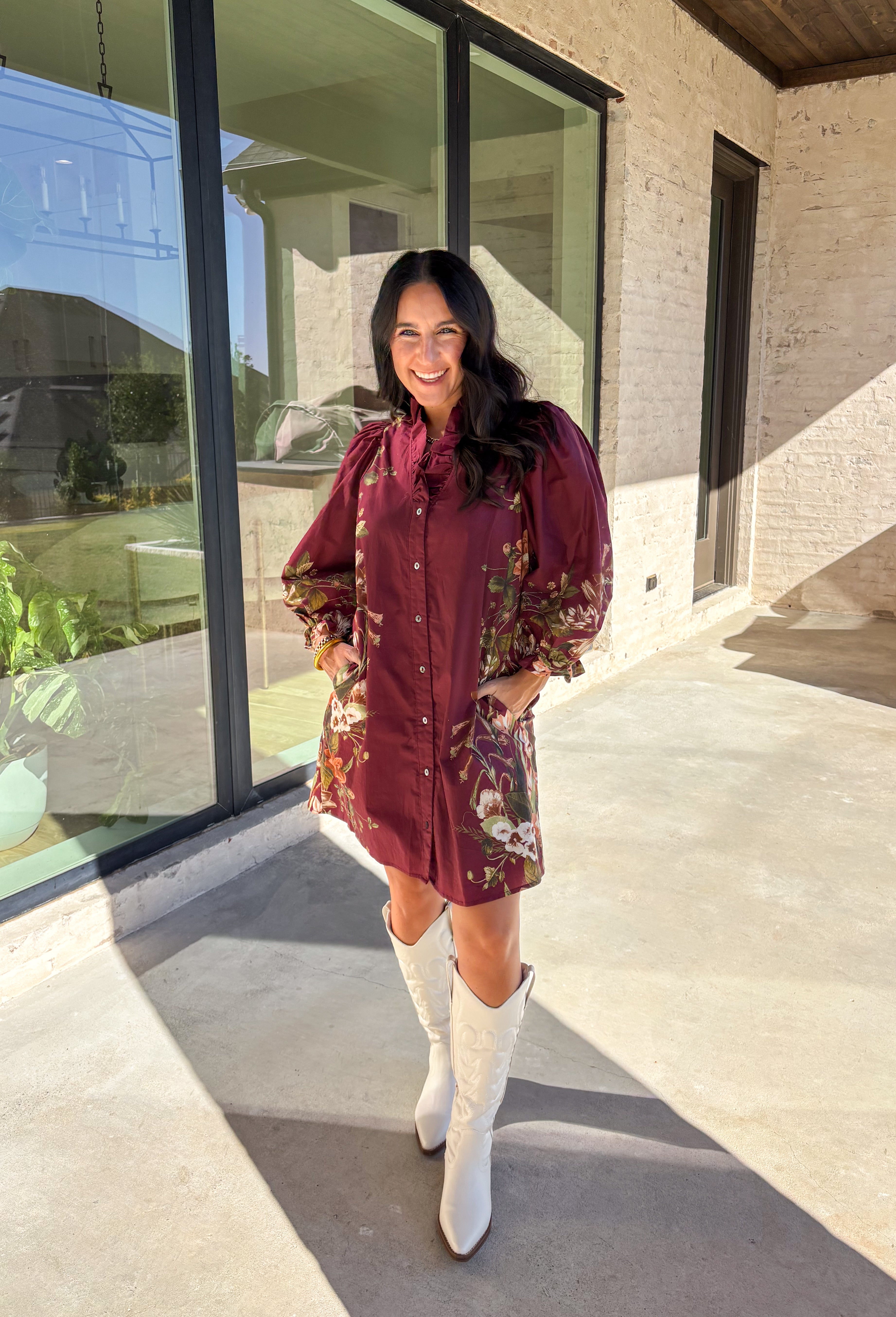 This burgundy button-down dress by Entro is a timeless piece with a fall-ready twist. Featuring a delicate floral print along the sides, it’s designed with a ruffled accent v-neckline for a touch of femininity. The elastic sleeves make for an easy, comfortable fit, while the full lining ensures effortless wear. With its rich color and flattering silhouette, this dress transitions seamlessly from day to night.
