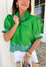 This green embroidered top is giving all the charming, autumnal details you love. The short sleeves feature smocked cuffs for a soft, feminine touch, while the blue embroidered border hem adds a pop of color that makes the whole look stand out. The ruffle band collar with button closure keeps it sweet and polished, perfect for pairing with jeans or layering under a cardigan as the weather cools. Lightweight and easy to wear, it’s a piece you’ll reach for again and again this season.