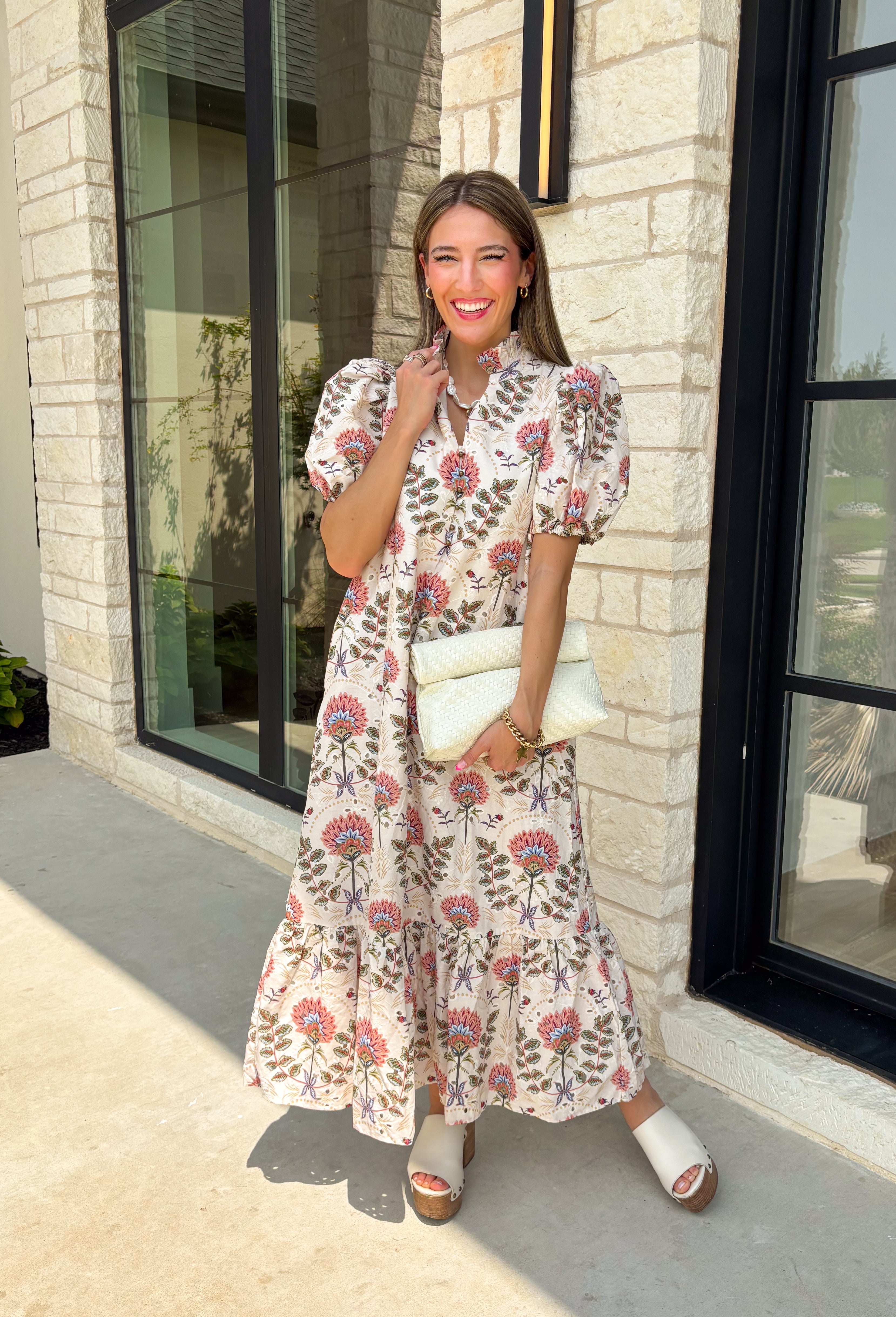 Effortlessly feminine and timelessly beautiful, this floral midi dress is a piece you'll love wearing from the first crisp days of fall through the holiday season. Designed with a rich navy backdrop and adorned with an olive and brown floral print, it captures the warm, earthy tones of autumn while remaining classic enough to wear year after year. The ruffled neckline, puff sleeves, and button-front details create a polished silhouette.