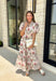 Effortlessly feminine and timelessly beautiful, this floral midi dress is a piece you'll love wearing from the first crisp days of fall through the holiday season. Designed with a rich navy backdrop and adorned with an olive and brown floral print, it captures the warm, earthy tones of autumn while remaining classic enough to wear year after year. The ruffled neckline, puff sleeves, and button-front details create a polished silhouette.
