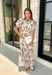 Effortlessly feminine and timelessly beautiful, this floral midi dress is a piece you'll love wearing from the first crisp days of fall through the holiday season. Designed with a rich navy backdrop and adorned with an olive and brown floral print, it captures the warm, earthy tones of autumn while remaining classic enough to wear year after year. The ruffled neckline, puff sleeves, and button-front details create a polished silhouette.