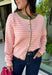 Bright colors come together beautifully in this cozy striped cardigan! Featuring pink and salmon stripes accented with an olive trim, this timeless knit adds the perfect pop of seasonal color to any outfit. The button-down front offers endless styling options, while the ribbed neckline gives it a classic finish. Soft, lightweight, and easy to layer, this cardigan is perfect for everything from office days and coffee dates to football weekends and crisp autumn afternoons.