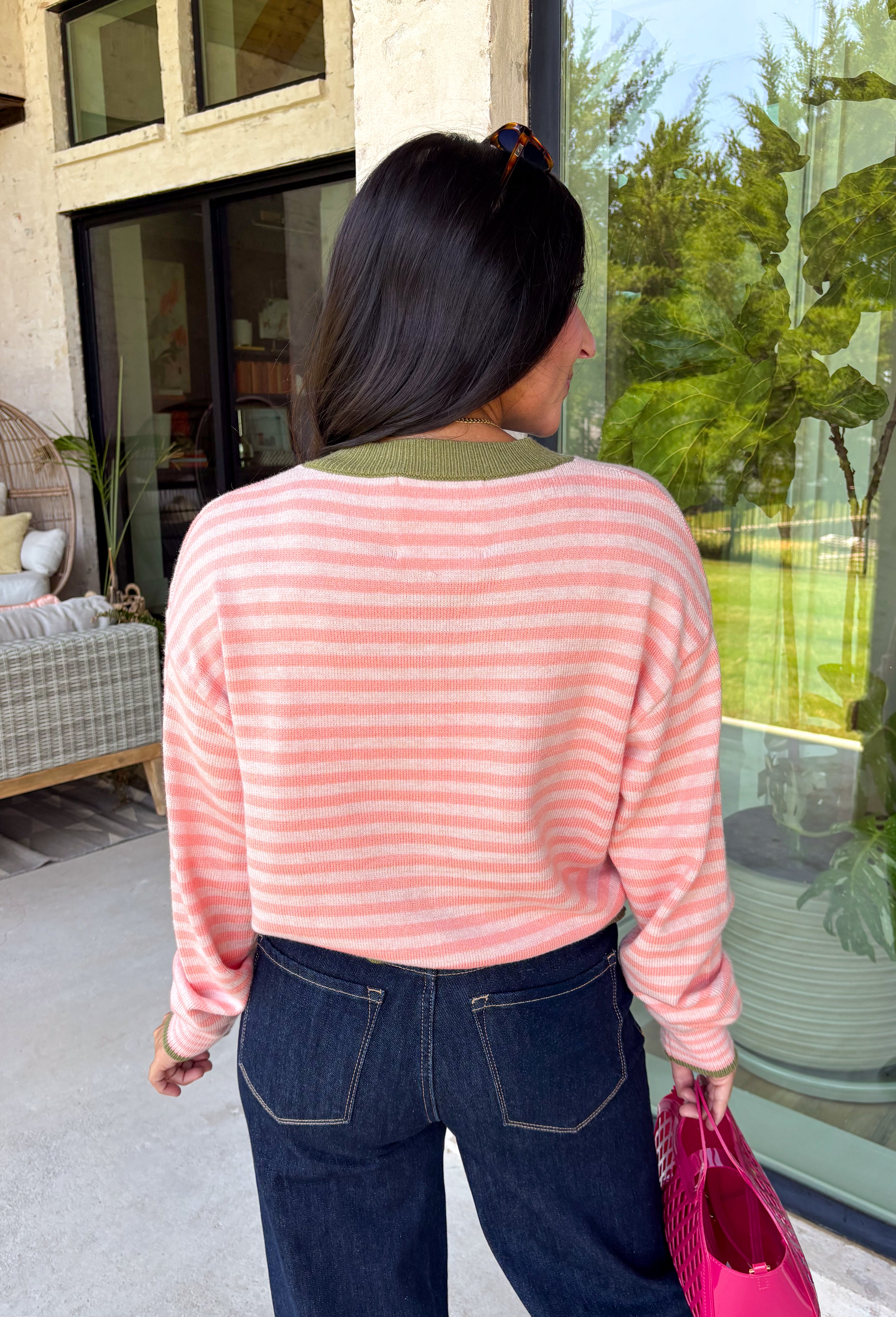 Bright colors come together beautifully in this cozy striped cardigan! Featuring pink and salmon stripes accented with an olive trim, this timeless knit adds the perfect pop of seasonal color to any outfit. The button-down front offers endless styling options, while the ribbed neckline gives it a classic finish. Soft, lightweight, and easy to layer, this cardigan is perfect for everything from office days and coffee dates to football weekends and crisp autumn afternoons.