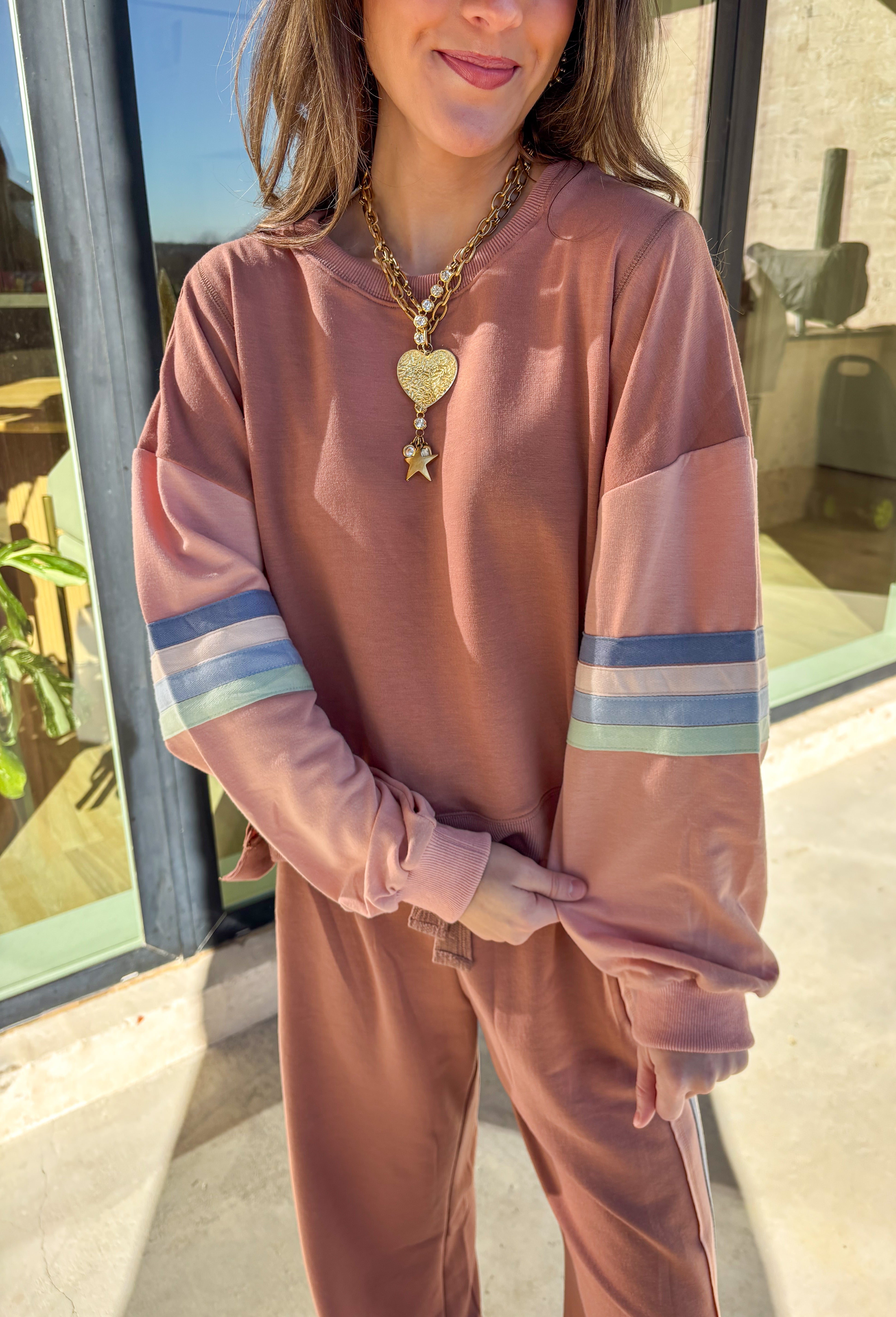 Brighten your spring wardrobe with this mauve two-piece set by New In. Designed with a soft, lightweight feel and a relaxed fit, this matching top and wide-leg pant combo is perfect for casual days and laid-back weekends. The blue, light mauve, and sage stripe detailing adds a cheerful pop of color, while the drawstring elastic waist keeps it comfy and easy to wear all day long.