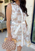 Soft, timeless, and perfect for spring days, this sleeveless tan dress is an effortless go-to for looking put together with minimal effort. Featuring a white floral print throughout, it has a fresh, neutral feel that’s easy to dress up or keep casual. The hidden button-down design and collared neckline give it a classic touch, while white trim along the front adds a clean contrast detail. 
