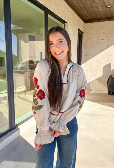 This ecru long sleeve top by Entro is the perfect blend of cozy neutrals and fall charm. Designed with puff sleeves and beautiful floral embroidery, it adds a soft, feminine touch to any outfit. The contrast piping at the neckline and waist gives it a flattering shape, while the smocked cuffs with ruffle edges add a sweet finishing detail. Effortless and chic, this top transitions perfectly from weekday wear to weekend outings.