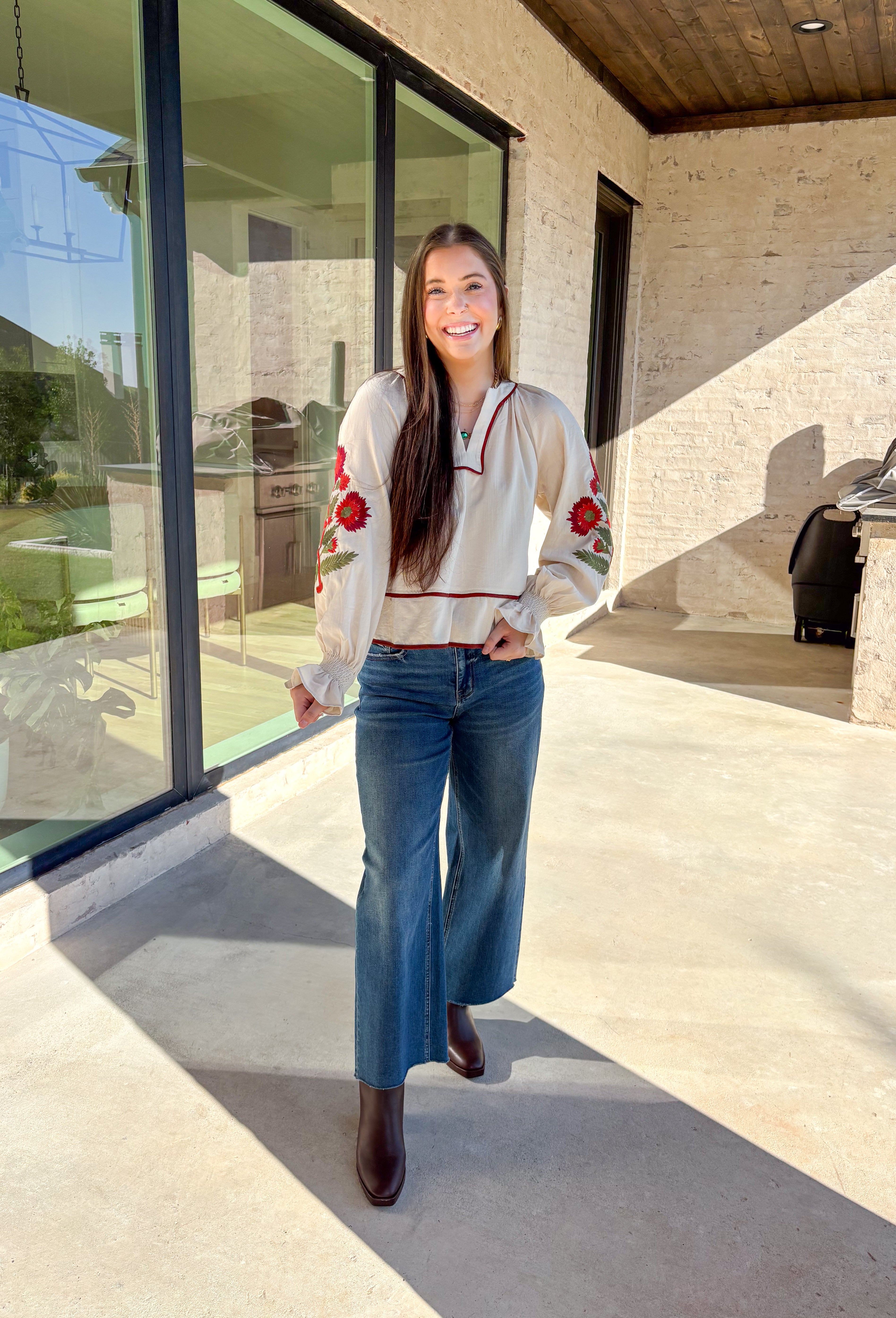 This ecru long sleeve top by Entro is the perfect blend of cozy neutrals and fall charm. Designed with puff sleeves and beautiful floral embroidery, it adds a soft, feminine touch to any outfit. The contrast piping at the neckline and waist gives it a flattering shape, while the smocked cuffs with ruffle edges add a sweet finishing detail. Effortless and chic, this top transitions perfectly from weekday wear to weekend outings.