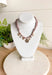 Playful and trendy, this tan bandana necklace is full of personality. Detailed with a mix of eclectic charms—including a sparkling crystal star, gold bow, pearls, gold pendant, gold heart, and a gold cowboy boot—it’s the perfect statement piece to add fun flair to any outfit. With a 16" length and 3" extender, you can adjust it to layer with other necklaces or let it shine on its own. A must-have for adding a pop of charm to your wardrobe.