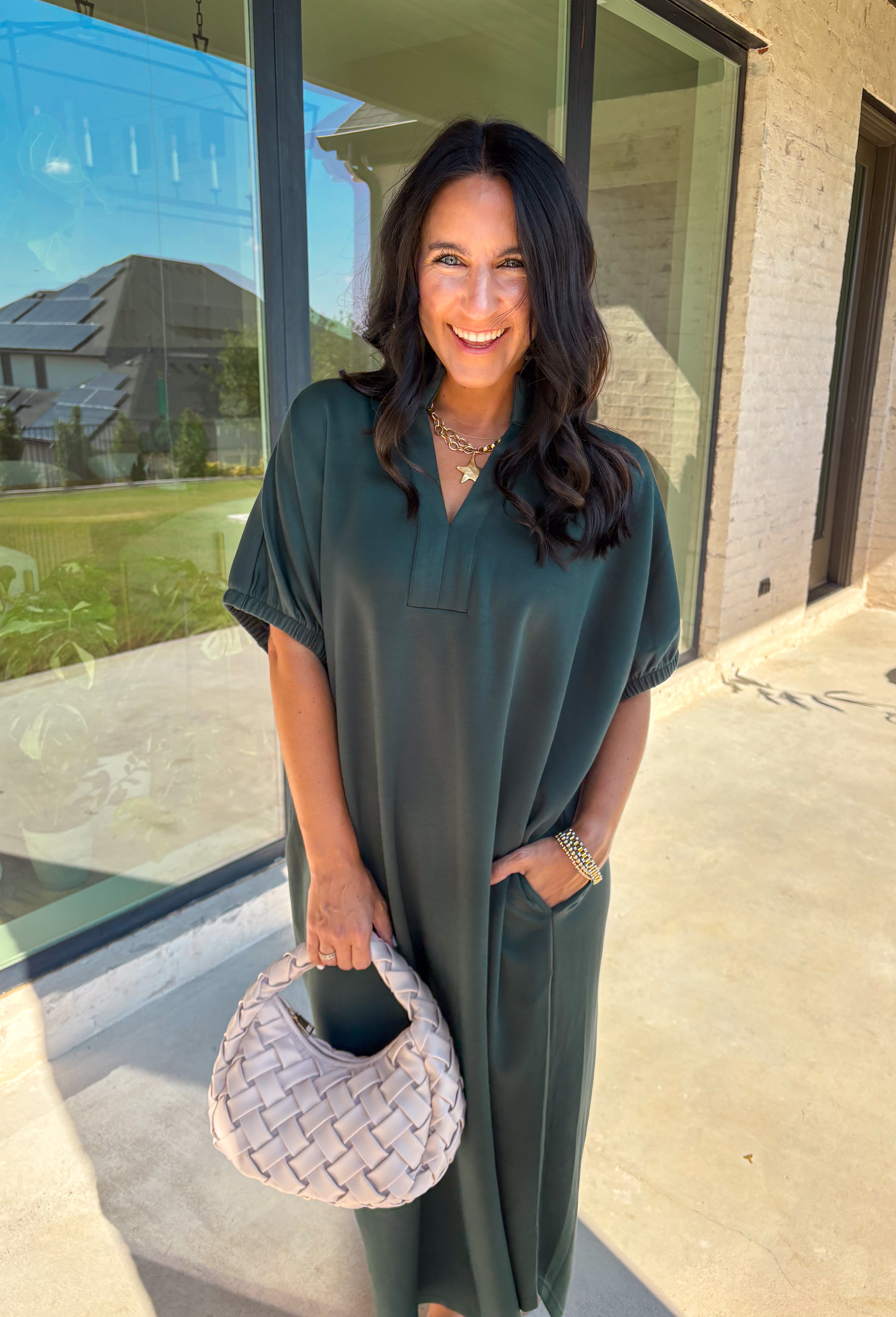 Effortless and versatile, this forest green midi dress is an easy favorite for fall. Designed with a band collar v-neckline and elasticated short sleeves, it offers both structure and comfort. Side pockets keep it practical, while the soft, stretchy fabric blend makes it perfect for all-day wear. You'll find yourself reaching for this dress all season long!