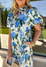 Soft, flowy, and full of spring romance, this off-white midi dress by Entro is an instant favorite. Featuring a beautiful green and blue floral print, it feels fresh and easy while still making a statement. The ruffled neckline and short puff sleeves add a sweet, feminine touch, while the button-front design keeps it classic and effortless. 