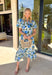 Soft, flowy, and full of spring romance, this off-white midi dress by Entro is an instant favorite. Featuring a beautiful green and blue floral print, it feels fresh and easy while still making a statement. The ruffled neckline and short puff sleeves add a sweet, feminine touch, while the button-front design keeps it classic and effortless. 