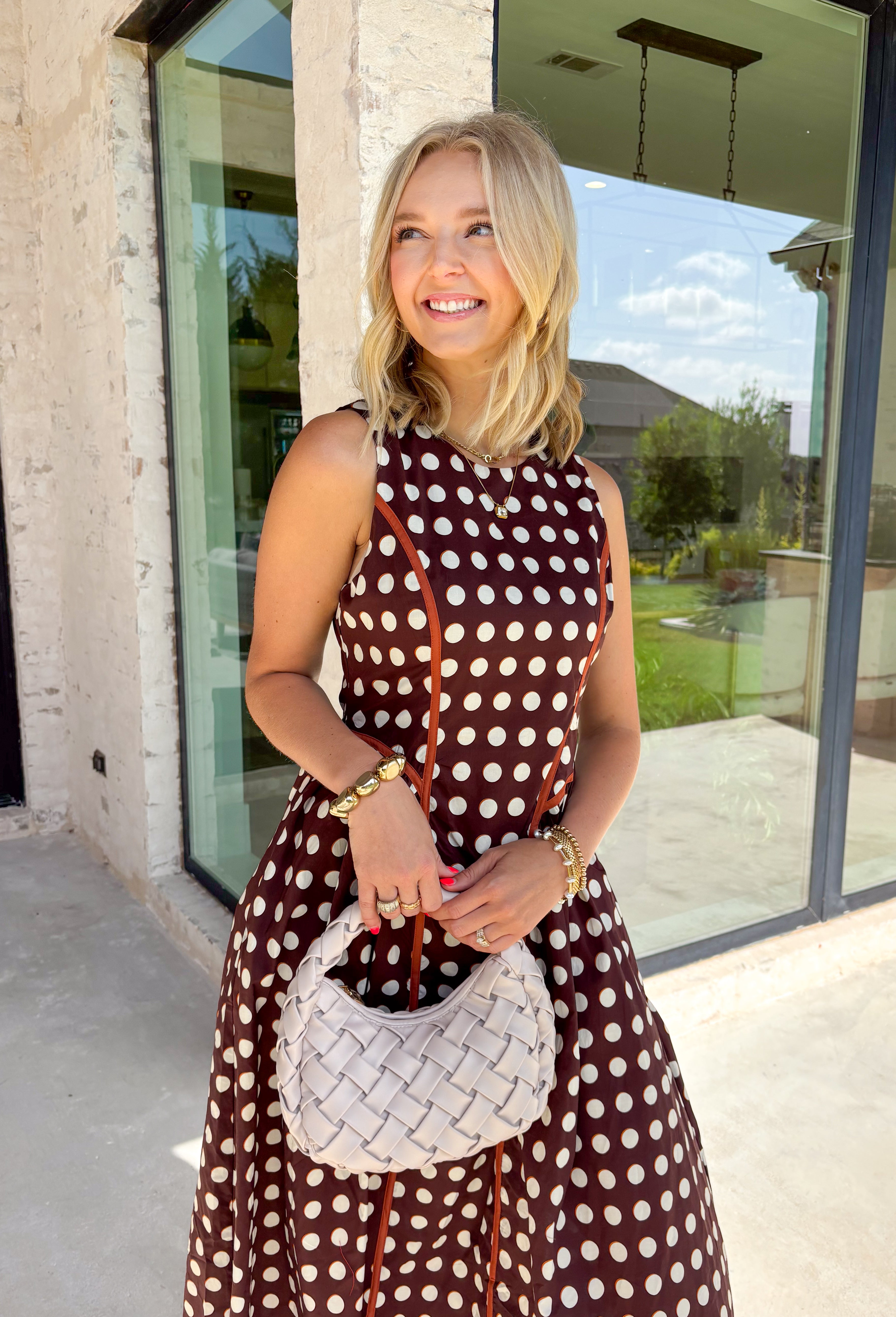 Classic polka dots never go out of style, and this charming midi dress from Entro is a timeless piece you'll wear for seasons to come. Designed with a rich brown backdrop and an off-white polka dot print, this sleeveless silhouette is effortlessly polished and easy to wear. Contrast piping adds a refined touch, while the back zipper creates a tailored fit. Finished with side pockets and a fully lined design, this cotton midi dress is perfect for everything.