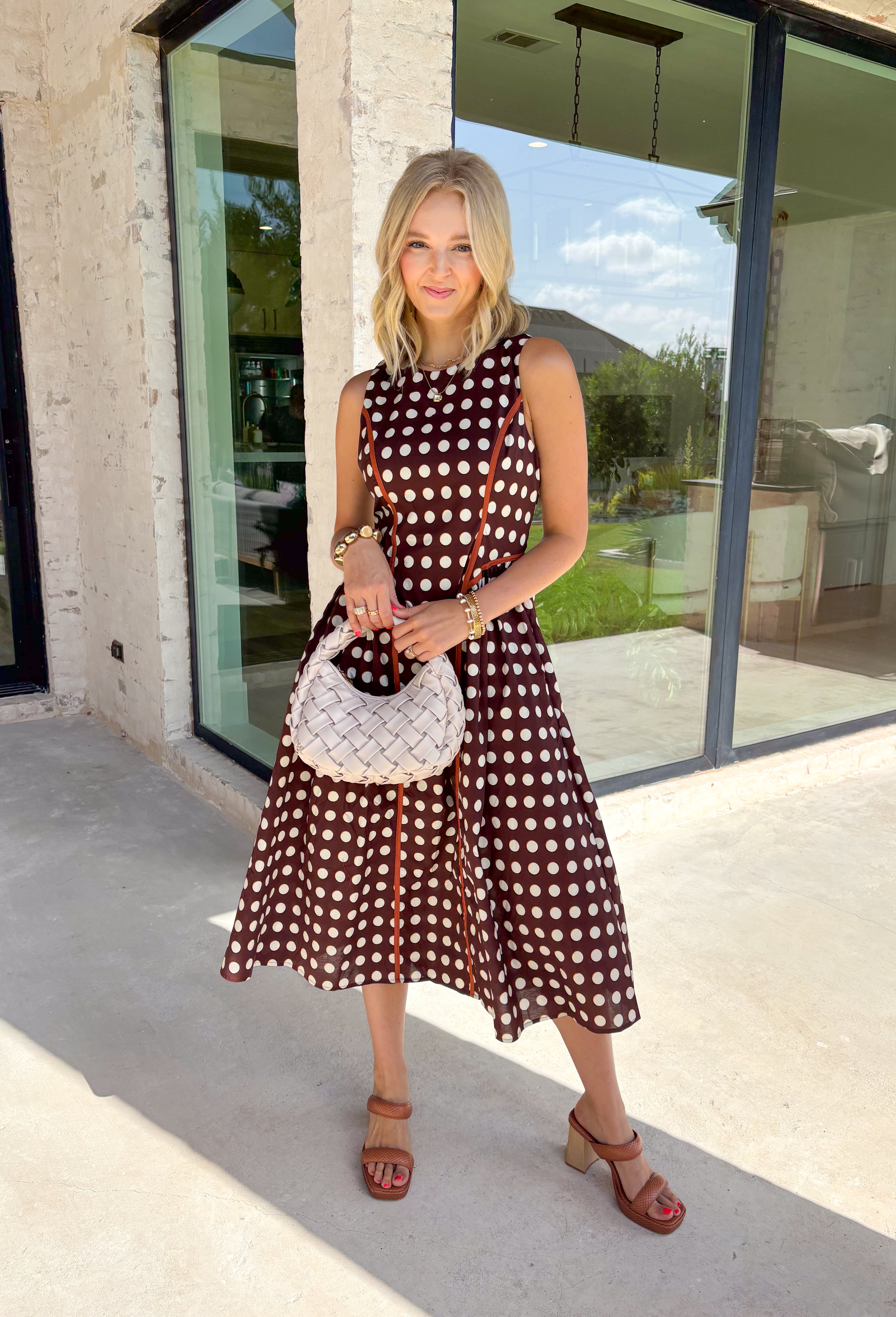 Classic polka dots never go out of style, and this charming midi dress from Entro is a timeless piece you'll wear for seasons to come. Designed with a rich brown backdrop and an off-white polka dot print, this sleeveless silhouette is effortlessly polished and easy to wear. Contrast piping adds a refined touch, while the back zipper creates a tailored fit. Finished with side pockets and a fully lined design, this cotton midi dress is perfect for everything.