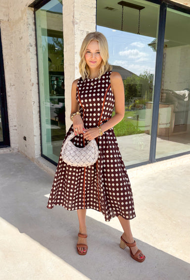 Classic polka dots never go out of style, and this charming midi dress from Entro is a timeless piece you'll wear for seasons to come. Designed with a rich brown backdrop and an off-white polka dot print, this sleeveless silhouette is effortlessly polished and easy to wear. Contrast piping adds a refined touch, while the back zipper creates a tailored fit. Finished with side pockets and a fully lined design, this cotton midi dress is perfect for everything.