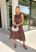 Classic polka dots never go out of style, and this charming midi dress from Entro is a timeless piece you'll wear for seasons to come. Designed with a rich brown backdrop and an off-white polka dot print, this sleeveless silhouette is effortlessly polished and easy to wear. Contrast piping adds a refined touch, while the back zipper creates a tailored fit. Finished with side pockets and a fully lined design, this cotton midi dress is perfect for everything.