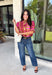 Bring playful pattern and timeless charm to your fall wardrobe with this beautifully detailed top from Entro. Featuring a unique mix of stripe and polka dot prints in rich shades of plum, magenta, and olive, this eye-catching blouse is perfect for adding personality to your everyday style. The feminine ruffle neckline and button-front design create a polished look, while the short puff sleeves are finished with smocked ruffle cuffs for an extra touch of charm. 