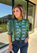 Bring playful pattern and timeless charm to your fall wardrobe with this beautifully detailed top from Entro. Featuring a unique mix of stripe and polka dot prints in rich shades of olive and blue, this eye-catching blouse is perfect for adding personality to your everyday style. The feminine ruffle neckline and button-front design create a polished look, while the short puff sleeves are finished with smocked ruffle cuffs for an extra touch of charm. 