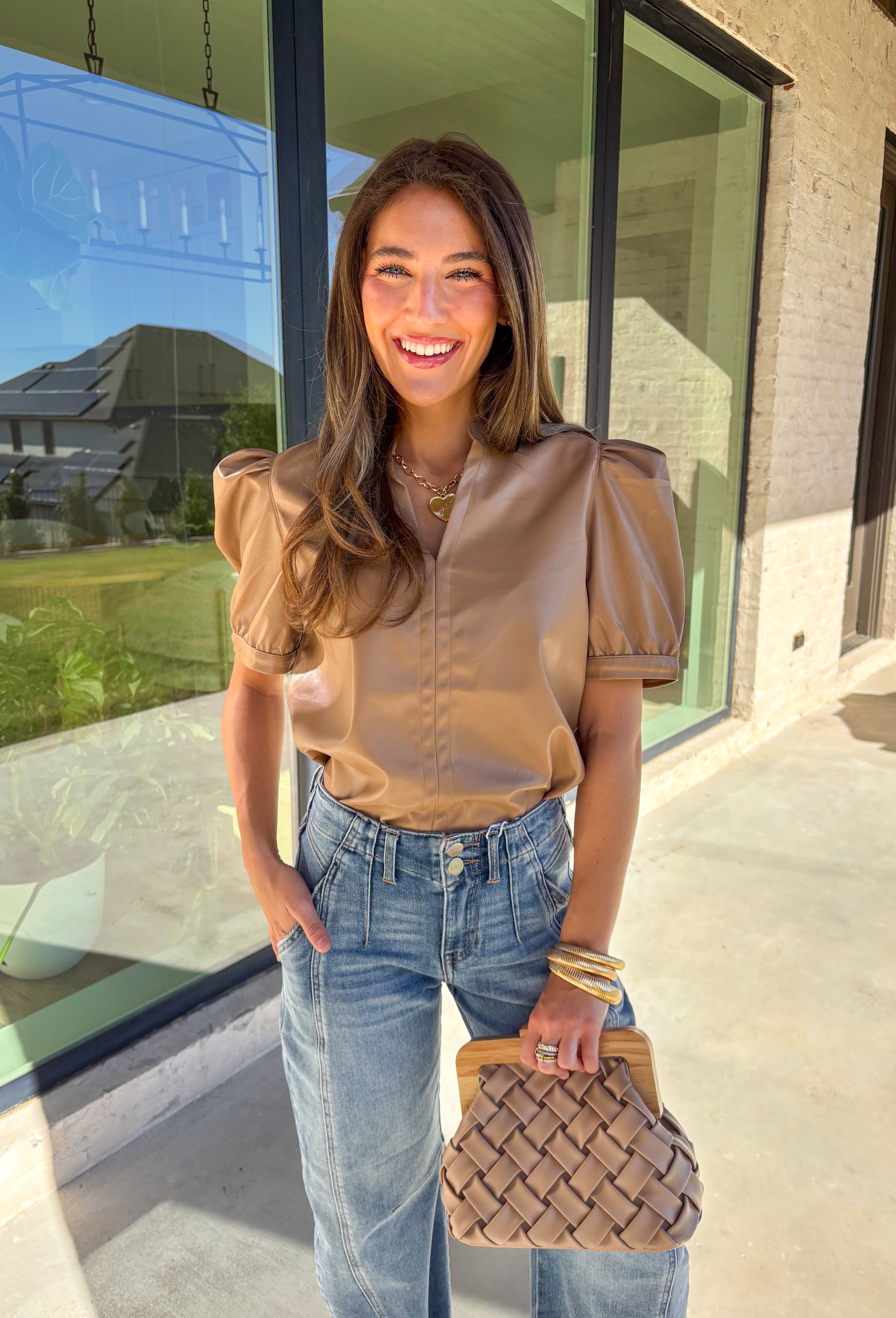 This light brown faux leather top by Fate is the perfect mix of sleek and modern. Designed with a flattering v-neckline and short sleeves, it adds a chic edge to any outfit while keeping your look polished and effortless. The buttery-soft faux leather gives it a touch of luxury, making it perfect for a night out or an elevated everyday style.