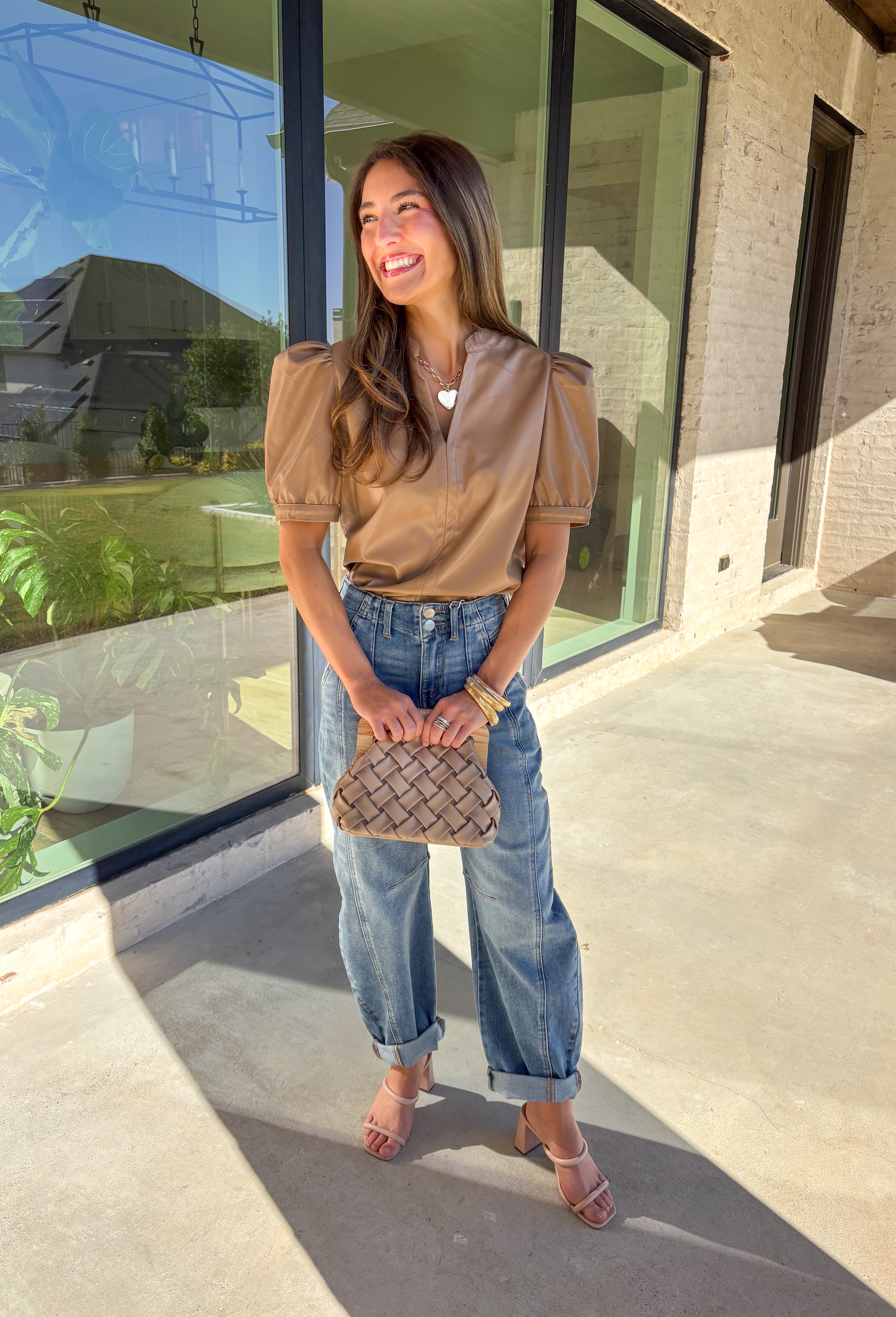 This light brown faux leather top by Fate is the perfect mix of sleek and modern. Designed with a flattering v-neckline and short sleeves, it adds a chic edge to any outfit while keeping your look polished and effortless. The buttery-soft faux leather gives it a touch of luxury, making it perfect for a night out or an elevated everyday style.