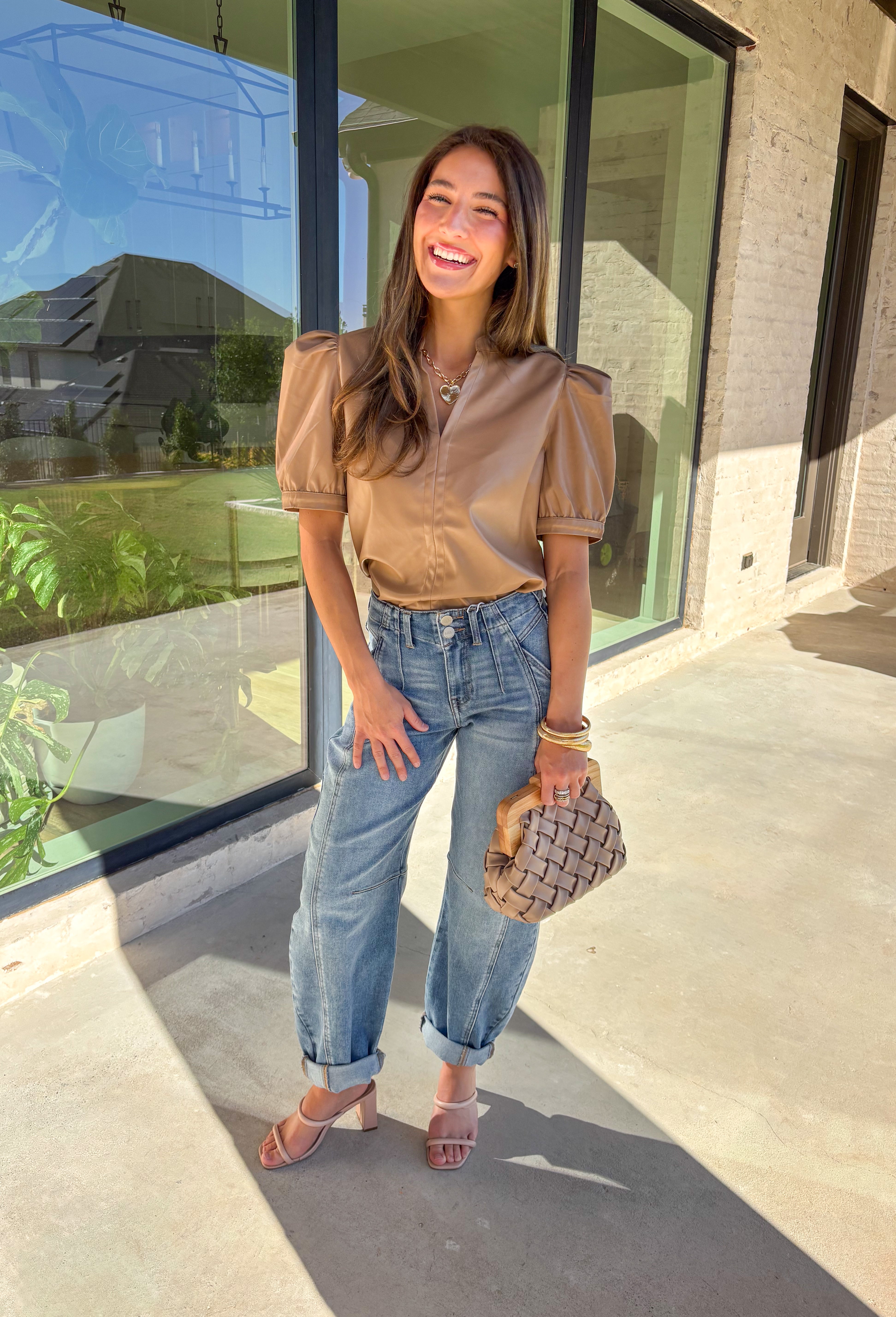 This light brown faux leather top by Fate is the perfect mix of sleek and modern. Designed with a flattering v-neckline and short sleeves, it adds a chic edge to any outfit while keeping your look polished and effortless. The buttery-soft faux leather gives it a touch of luxury, making it perfect for a night out or an elevated everyday style.