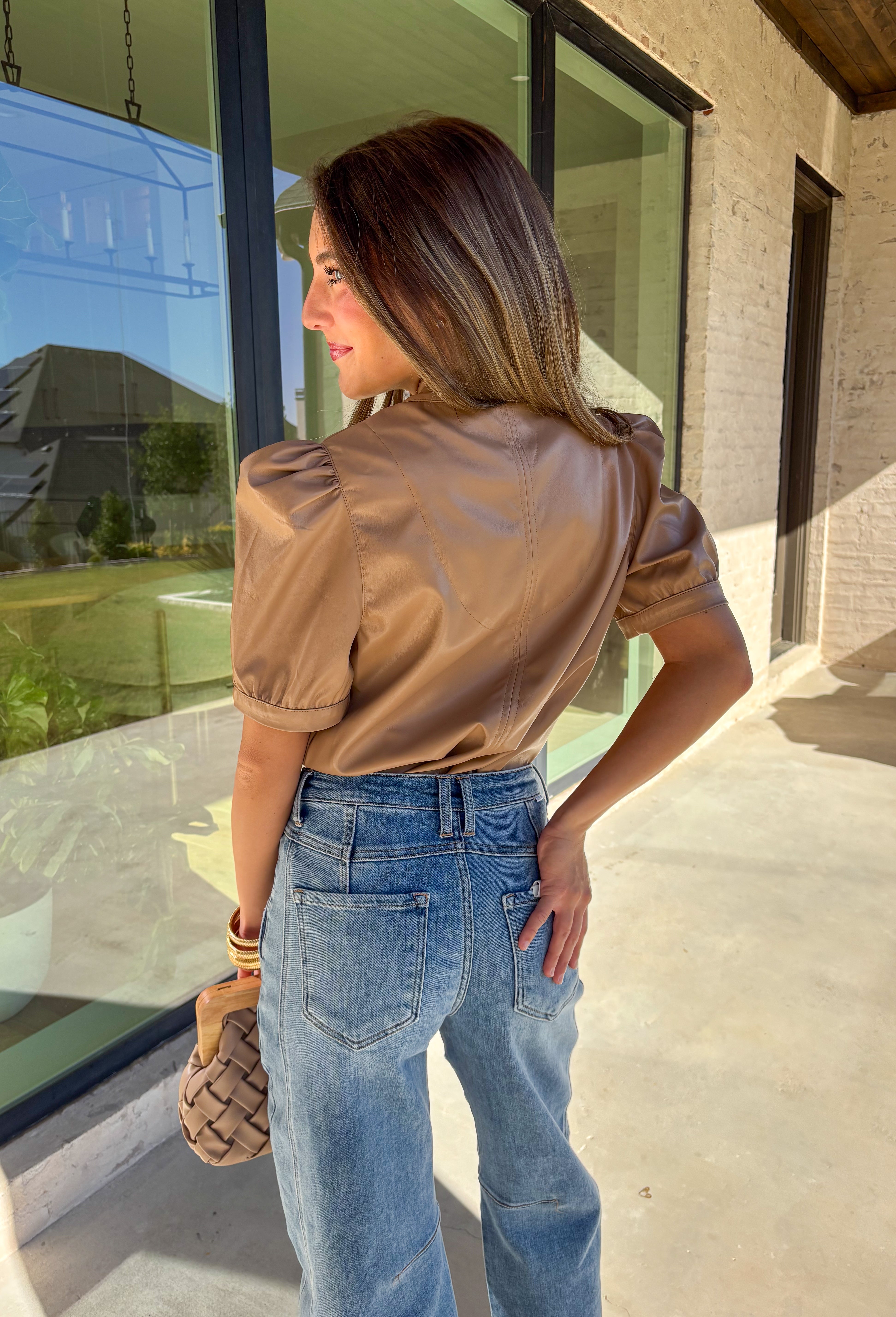 This light brown faux leather top by Fate is the perfect mix of sleek and modern. Designed with a flattering v-neckline and short sleeves, it adds a chic edge to any outfit while keeping your look polished and effortless. The buttery-soft faux leather gives it a touch of luxury, making it perfect for a night out or an elevated everyday style.