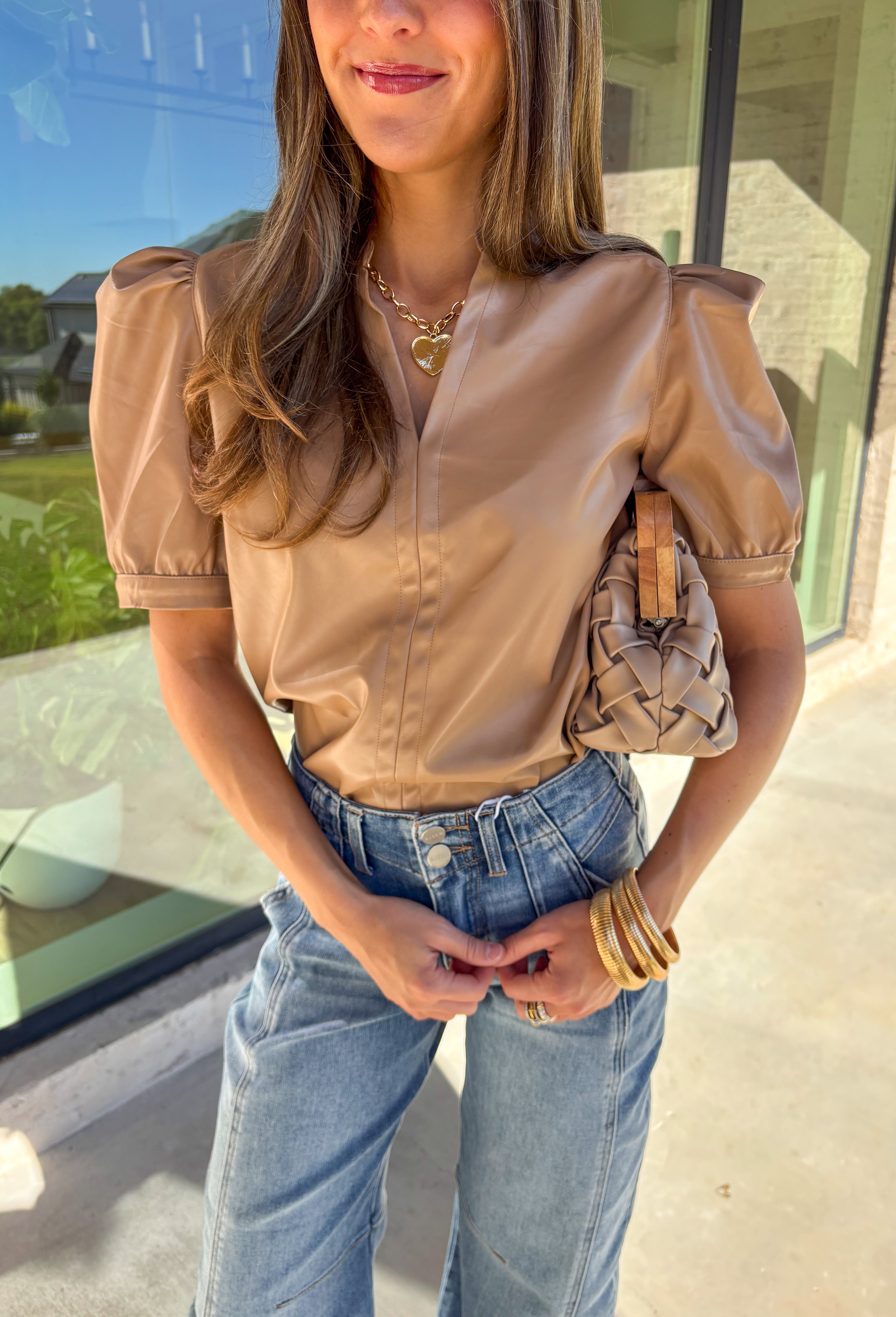 This light brown faux leather top by Fate is the perfect mix of sleek and modern. Designed with a flattering v-neckline and short sleeves, it adds a chic edge to any outfit while keeping your look polished and effortless. The buttery-soft faux leather gives it a touch of luxury, making it perfect for a night out or an elevated everyday style.