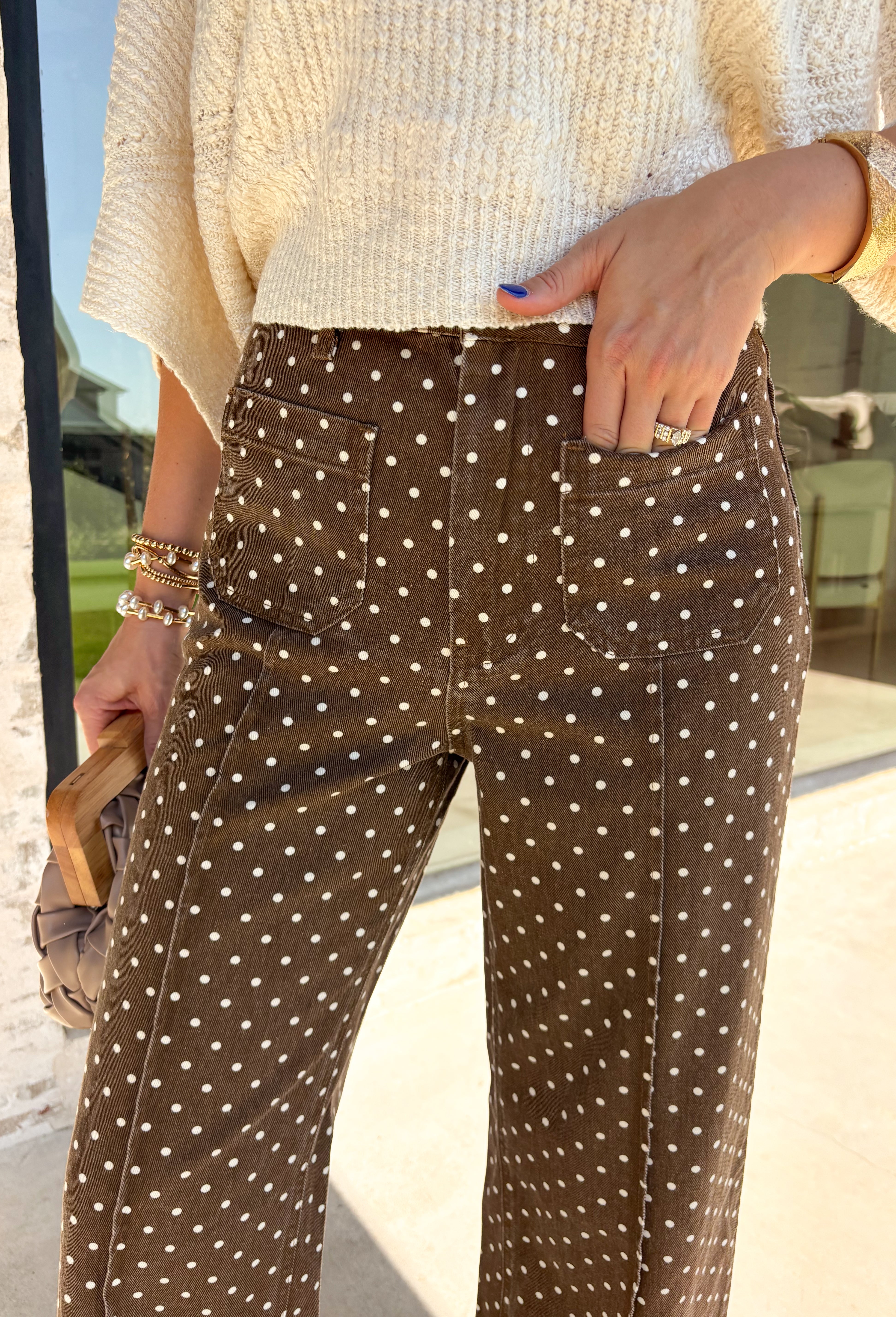 These wide leg pants from Entro are the perfect way to add a little personality to your everyday wardrobe. Designed in a rich brown denim with a classic white polka dot print, they offer a fun yet timeless look that's easy to style all season long. The flattering wide leg silhouette creates an effortlessly elevated feel, while the sturdy cotton denim and functional pockets make them as practical as they are stylish. 