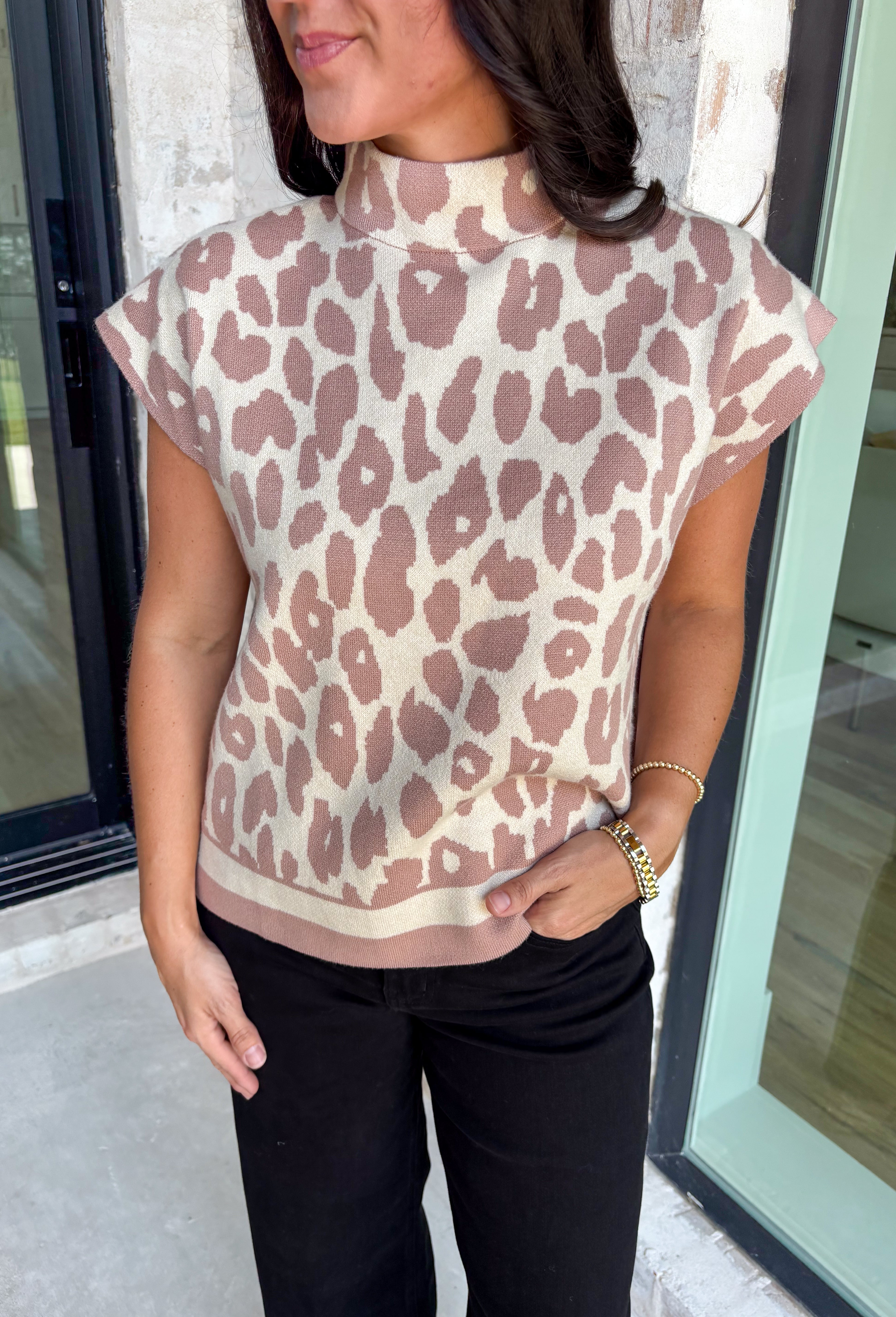 Elevated and cozy with a touch of wild, this neutral leopard sweater is the perfect statement knit for fall. The mock neck adds a modern, polished feel, while the short sleeves make it a versatile piece for layering or wearing solo during transitional weather. Crafted from a soft, stretchy blend, it’s as comfortable as it is chic—easy to pair with everything from jeans to skirts for an instant outfit upgrade.