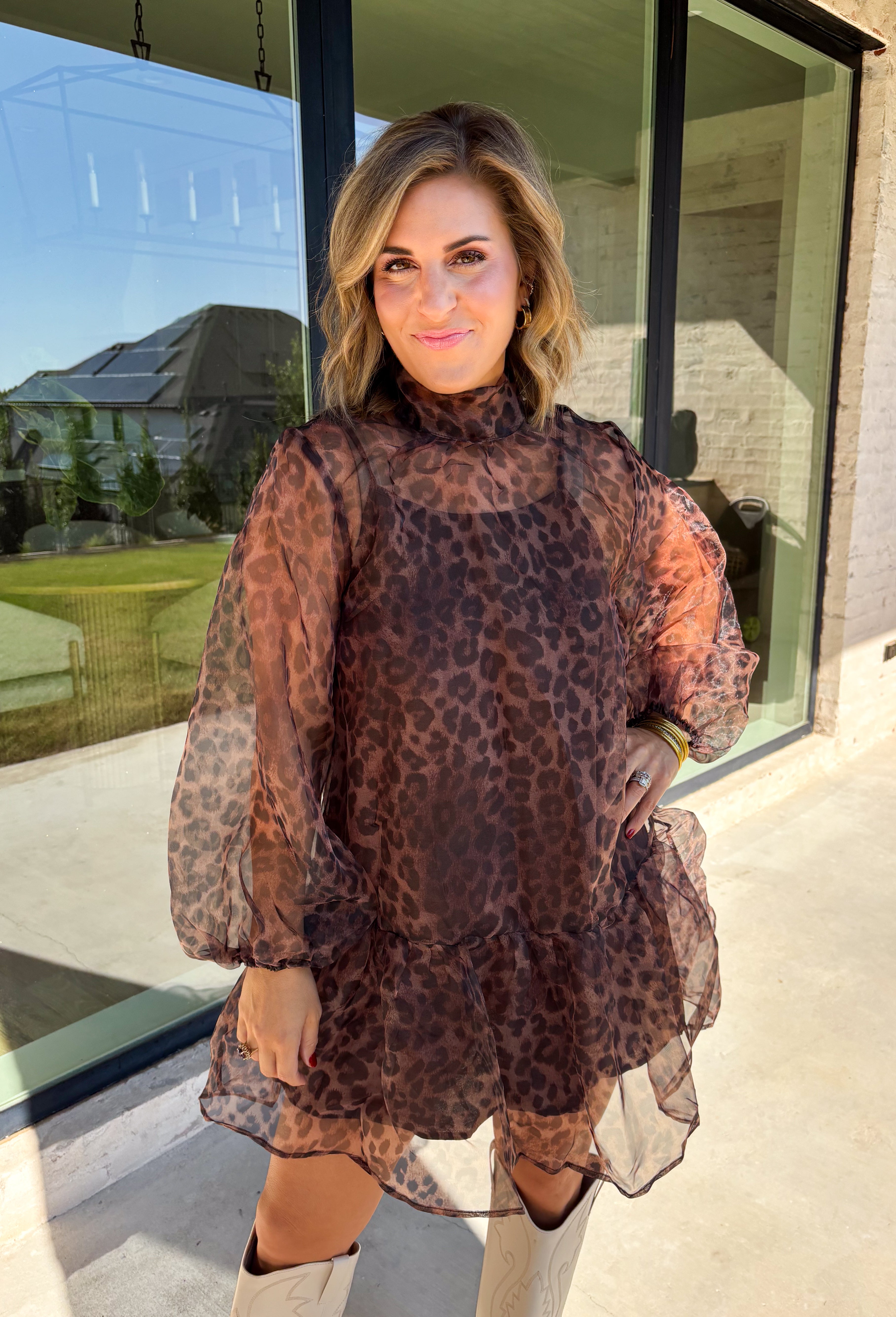 Turn up the print with this leopard dress from Entro, made for days when your outfit deserves a little extra personality. The classic leopard pattern pairs with a mock neckline for a put-together look, while the self-tie detail at the back adds a pretty finishing touch. Long balloon sleeves create soft volume and are finished with elastic cuffs for a comfortable fit. A playful ruffle hem adds movement to the shorter silhouette, and the lined design provides coverage beneath the semi-sheer woven fabric.
