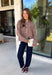 Cozy meets classic in this brown and taupe mini chevron knit cardigan by &Merci. The playful chevron pattern gives this sweater a fun, vintage-inspired feel, while the colorful button-down front adds an unexpected pop of personality. Designed with a mock neckline and a soft, cozy knit texture, it’s perfect for keeping warm when the temperatures start to drop. The classic brown and taupe color combination makes it an easy choice for winter days, holiday outings, and casual weekends. 