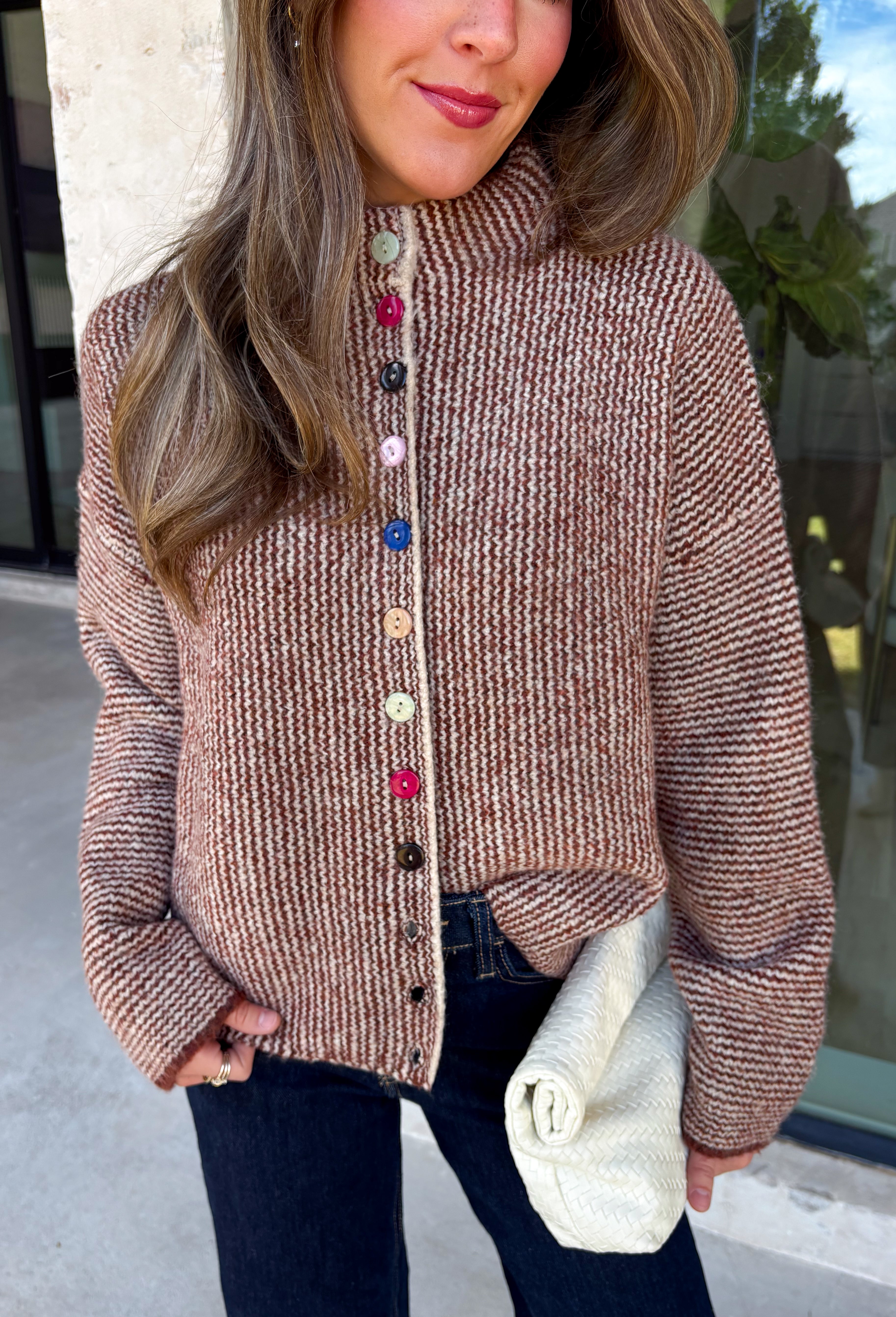 Cozy meets classic in this brown and taupe mini chevron knit cardigan by &Merci. The playful chevron pattern gives this sweater a fun, vintage-inspired feel, while the colorful button-down front adds an unexpected pop of personality. Designed with a mock neckline and a soft, cozy knit texture, it’s perfect for keeping warm when the temperatures start to drop. The classic brown and taupe color combination makes it an easy choice for winter days, holiday outings, and casual weekends. 