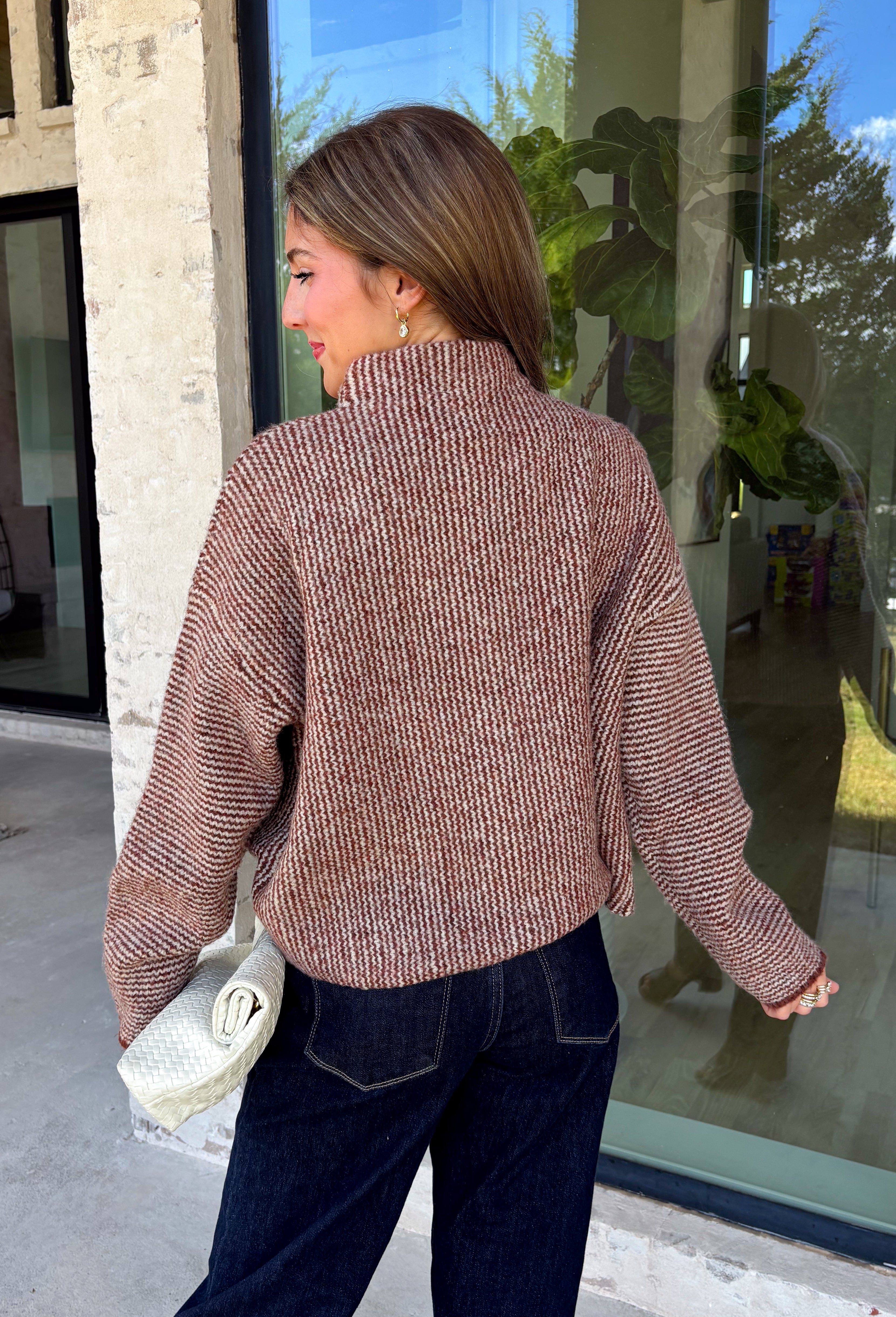 Cozy meets classic in this brown and taupe mini chevron knit cardigan by &Merci. The playful chevron pattern gives this sweater a fun, vintage-inspired feel, while the colorful button-down front adds an unexpected pop of personality. Designed with a mock neckline and a soft, cozy knit texture, it’s perfect for keeping warm when the temperatures start to drop. The classic brown and taupe color combination makes it an easy choice for winter days, holiday outings, and casual weekends. 