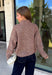 Cozy meets classic in this brown and taupe mini chevron knit cardigan by &Merci. The playful chevron pattern gives this sweater a fun, vintage-inspired feel, while the colorful button-down front adds an unexpected pop of personality. Designed with a mock neckline and a soft, cozy knit texture, it’s perfect for keeping warm when the temperatures start to drop. The classic brown and taupe color combination makes it an easy choice for winter days, holiday outings, and casual weekends. 