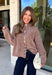 Cozy meets classic in this brown and taupe mini chevron knit cardigan by &Merci. The playful chevron pattern gives this sweater a fun, vintage-inspired feel, while the colorful button-down front adds an unexpected pop of personality. Designed with a mock neckline and a soft, cozy knit texture, it’s perfect for keeping warm when the temperatures start to drop. The classic brown and taupe color combination makes it an easy choice for winter days, holiday outings, and casual weekends. 