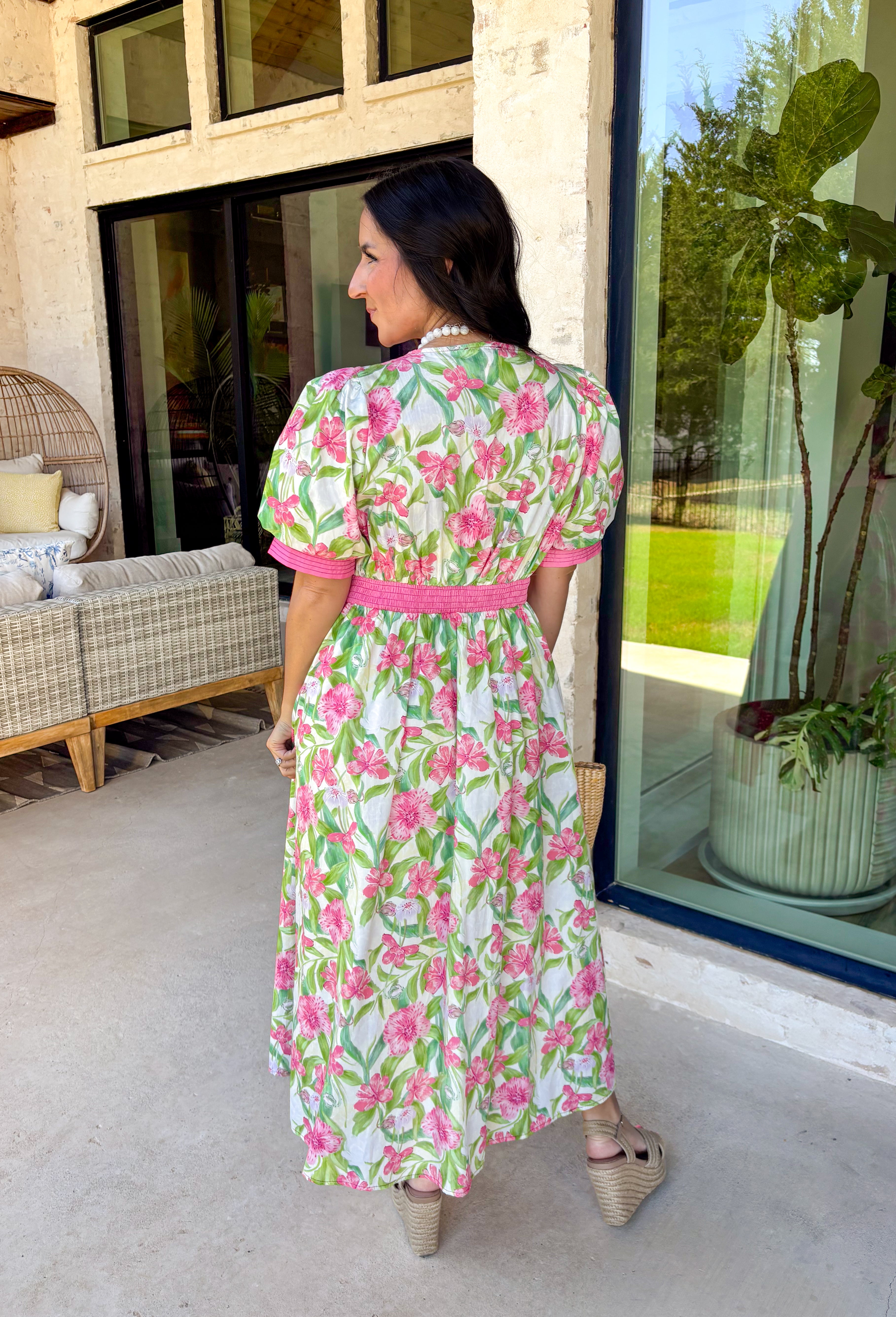 Fresh, flattering, and made for spring days, this off-white midi dress is an easy standout. Featuring a green and pink floral print throughout, it feels bright and cheerful, while the pink trim adds the sweetest pop of contrast. The front zipper closure gives it a modern touch, and the front slit makes it easy to move (and adds a little extra flair). 