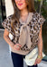 Give your sweater lineup a little wild side with this neutral leopard print top from Entro. The soft knit fabric and classic neutral shades make the statement print surprisingly easy to work into your everyday wardrobe. A coordinating self-tie scarf adds a fun, unexpected detail at the neckline and gives this sweater a little something extra. Short sleeves make it a great transitional piece, while the round neckline and ribbed hem keep the silhouette classic and easy to wear. 