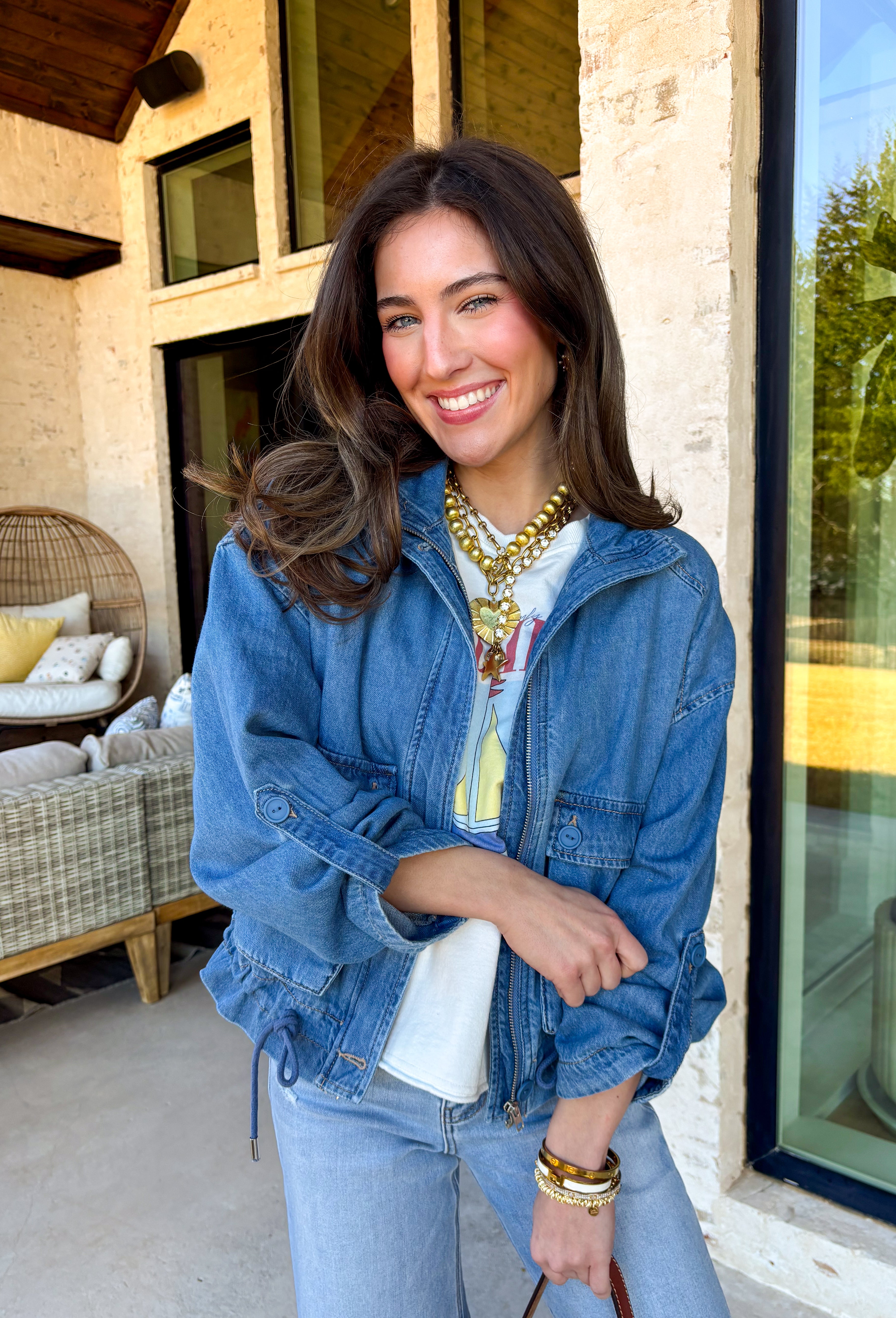 This medium wash denim jacket is the perfect spring layering piece you’ll reach for again and again. Designed with a modern front zipper closure, it offers an easy, throw-on-and-go feel while still looking polished. The mix of front buttoned chest pockets and side pockets adds both function and style, and the adjustable tie detail at the hem lets you customize the fit—cinch it in for shape or leave it relaxed for a laid-back vibe. Made from 100% cotton, this jacket feels structured yet breathable.