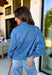 This medium wash denim jacket is the perfect spring layering piece you’ll reach for again and again. Designed with a modern front zipper closure, it offers an easy, throw-on-and-go feel while still looking polished. The mix of front buttoned chest pockets and side pockets adds both function and style, and the adjustable tie detail at the hem lets you customize the fit—cinch it in for shape or leave it relaxed for a laid-back vibe. Made from 100% cotton, this jacket feels structured yet breathable.