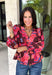 Rich autumn color and pretty details come together in this floral blouse from Entro. The warm brown background is covered in a fall-inspired floral print, making it an easy way to bring the colors of the season into your everyday wardrobe. A v-neckline and button-front closure keep the silhouette classic, while scalloped trim along the neckline and sleeve cuffs adds a sweet finishing touch. 