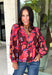 Rich autumn color and pretty details come together in this floral blouse from Entro. The warm brown background is covered in a fall-inspired floral print, making it an easy way to bring the colors of the season into your everyday wardrobe. A v-neckline and button-front closure keep the silhouette classic, while scalloped trim along the neckline and sleeve cuffs adds a sweet finishing touch. 