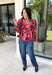 Rich autumn color and pretty details come together in this floral blouse from Entro. The warm brown background is covered in a fall-inspired floral print, making it an easy way to bring the colors of the season into your everyday wardrobe. A v-neckline and button-front closure keep the silhouette classic, while scalloped trim along the neckline and sleeve cuffs adds a sweet finishing touch. 