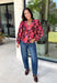 Rich autumn color and pretty details come together in this floral blouse from Entro. The warm brown background is covered in a fall-inspired floral print, making it an easy way to bring the colors of the season into your everyday wardrobe. A v-neckline and button-front closure keep the silhouette classic, while scalloped trim along the neckline and sleeve cuffs adds a sweet finishing touch. 
