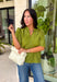 Classic details and rich autumn color come together beautifully in this effortlessly feminine blouse. Designed in a gorgeous olive green hue, this top features delicate embroidery that adds texture and timeless charm without overwhelming the look. The split neckline and puff sleeves create an elevated silhouette, while the scalloped trim along the hem and sleeve openings adds a sweet finishing touch. 