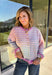 Bring a little extra color to cozy season with this striped knit cardigan from Twenitfourth. A playful mix of pink, purple, coral, blue, lavender, and off white gives this sweater a cheerful look that instantly brightens up cooler days. The button-down front makes it easy to wear closed as a top or open over your favorite tee or tank for a layered look.